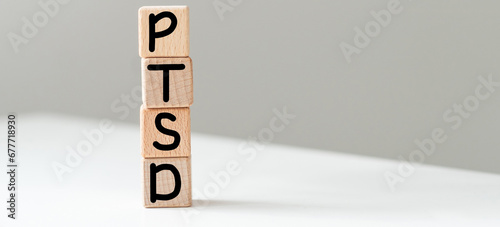 Posttraumatic stress disorder concept: Word PTSD and a falling pawn in motion