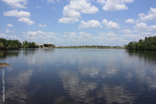 Scenic view of the Neches River with clouds reflecting on water surface in Beaumont, Texas photo