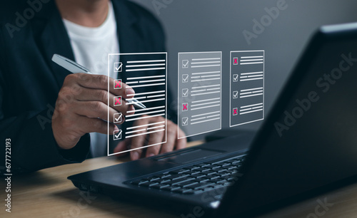 man uses pen to tick checkboxes on business performance checklist on virtual screen. Concept of filling out digital form checklists, doing assessments, questionnaires, clipboard work management