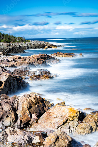 East Coast Long Exposure coastal picture with crashing waves on rocky headlands in Newfoundland and Labrador Canada. photo