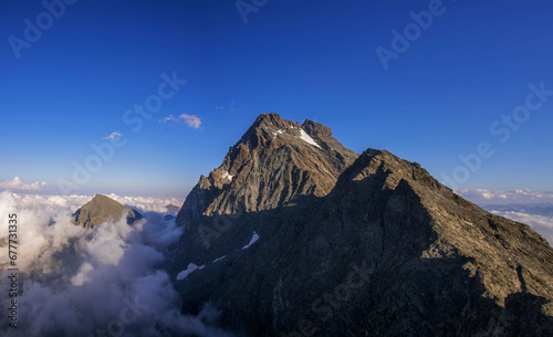 Obraz na płótnie Summer panoramic view of Monviso (Mount Viso or Monte Viso, 3841 metres), the symbol of the Cottian Alps, taken at sunset from an observation point 3100 meters above sea level. Piedmont, Italy. w salonie