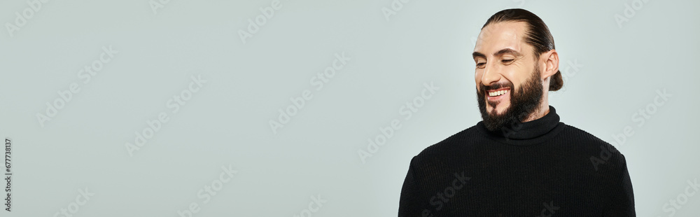 portrait of good looking arabic man with beard posing in turtleneck and smiling on grey, banner portrait of good looking arabic man with beard posing in turtleneck and smiling on grey, banner
