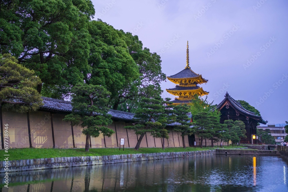 Aerial view of lake surrounded by buildings and dense trees in Kyoto Aerial view of lake surrounded by buildings and dense trees in Kyoto