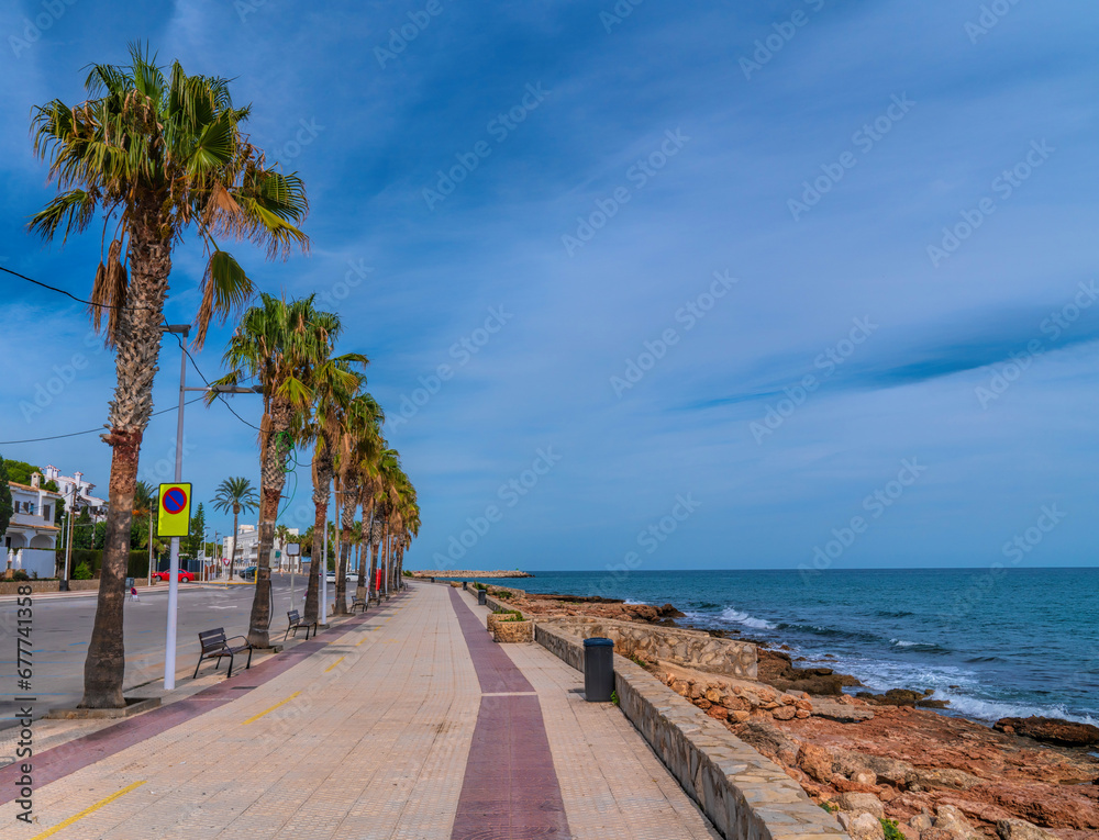 Alcossebre Spain promenade with palm trees between town and Platja de les Fonts beach
