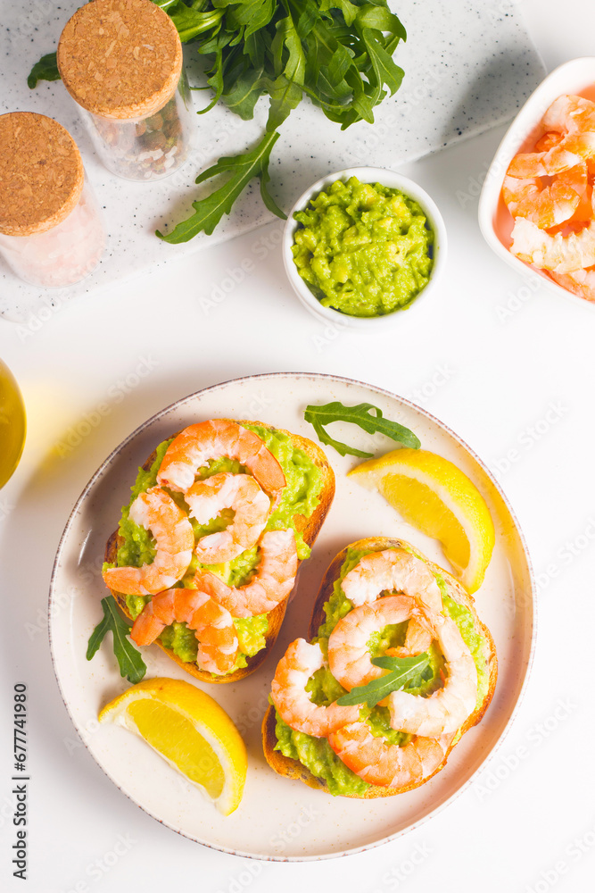 Shrimps on toast with avocado and lemon. Prawns. Breakfast concept. Bruschetta. 