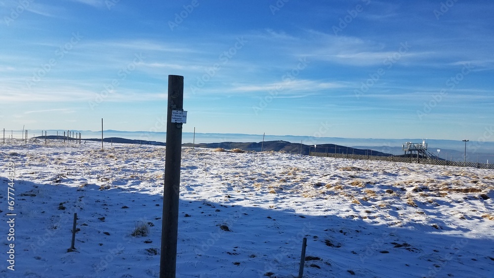Empty landscape covered in snow with blue sky in the background Empty landscape covered in snow with blue sky in the background