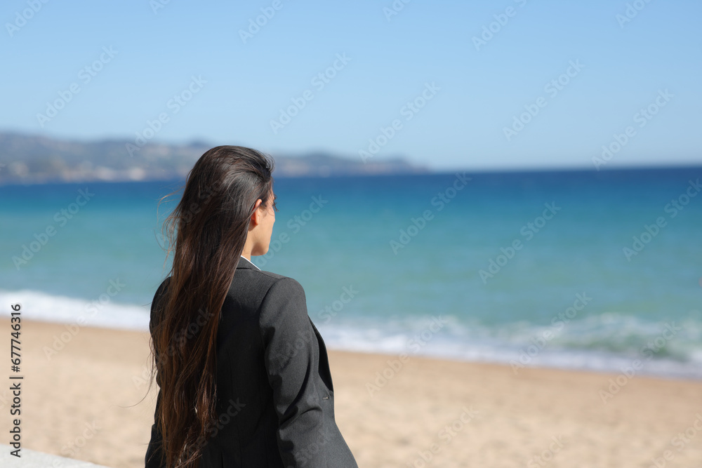 Executive relaxing contemplating ocean on the beach Executive relaxing contemplating ocean on the beach