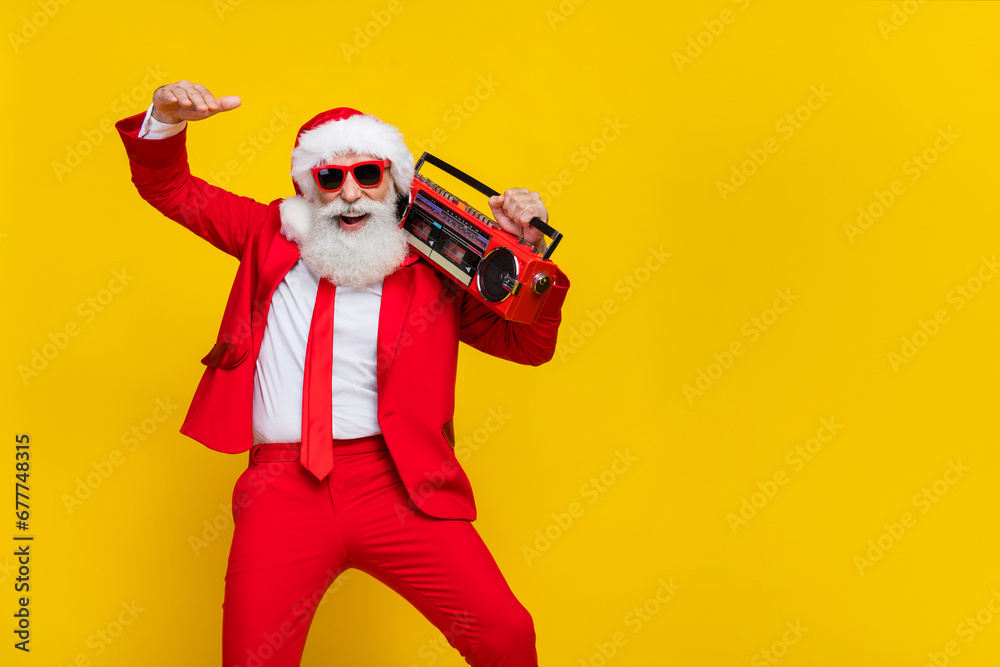 Portrait of positive cheerful person carry boombox have good mood x-mas noel isolated on yellow color background