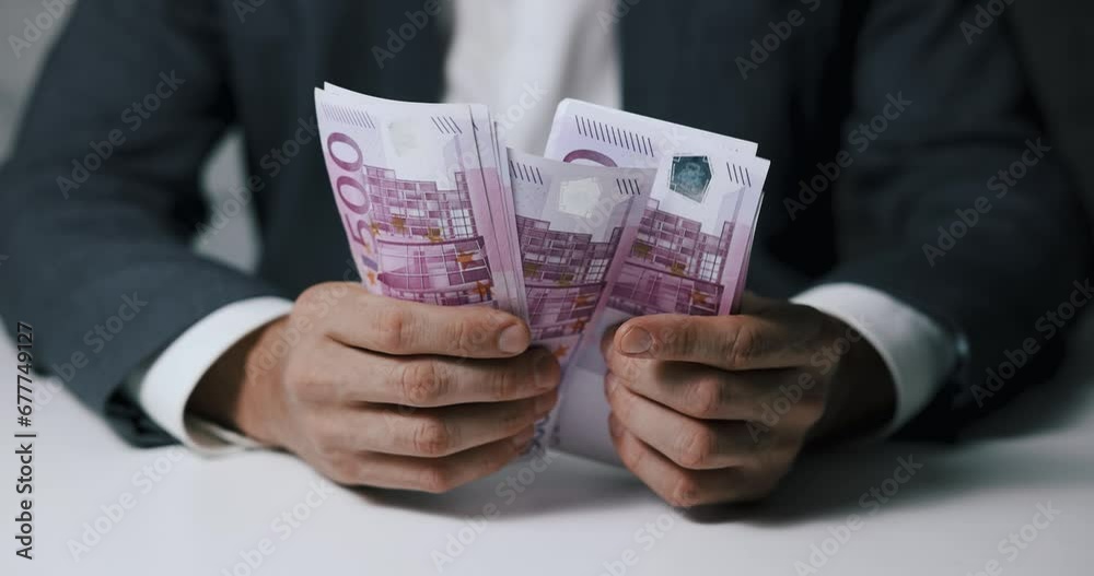closeup of businessman hands counting 500 euro money banknotes