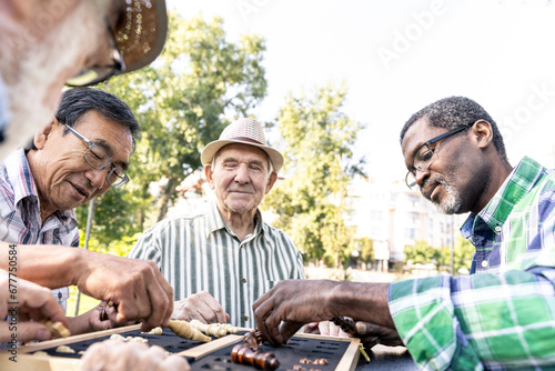 Group of senior friends playing games and making different activities at the park. Lifestyle concepts about seniority and third age