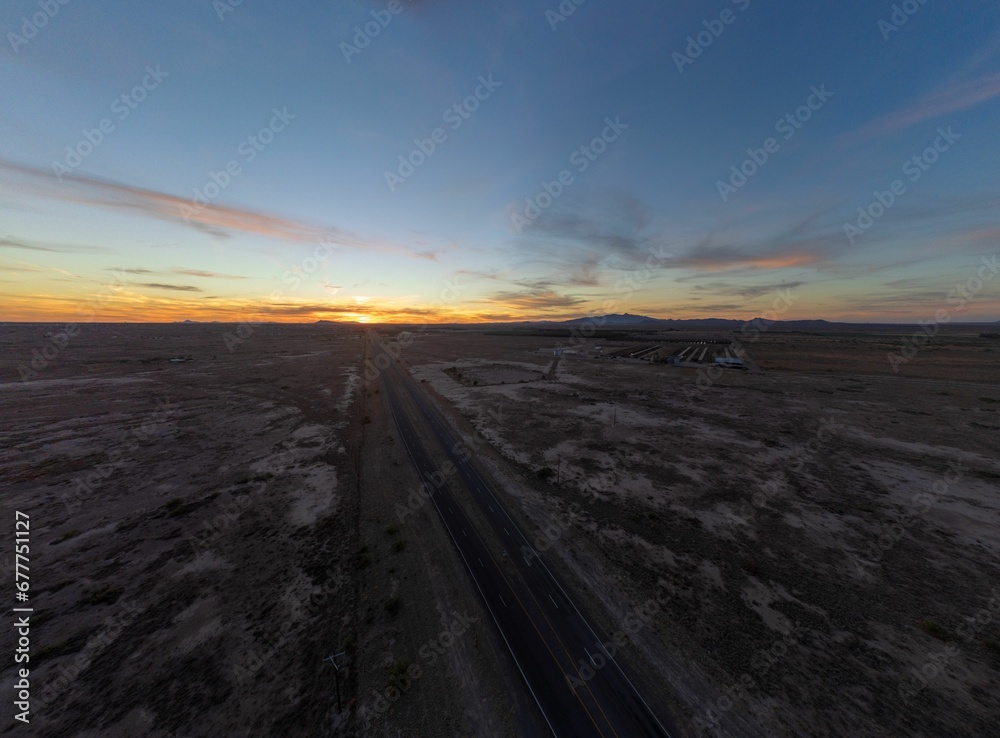 Aerial view of a sunset over the asphalt road