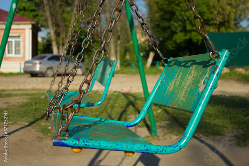 Sitting on a children's swing.