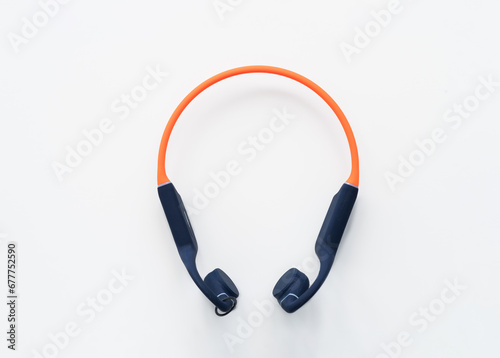 Wireless Waterproof Bone Conduction Headphones on a white background. Open ear design. Navy orange headphones, isolated.