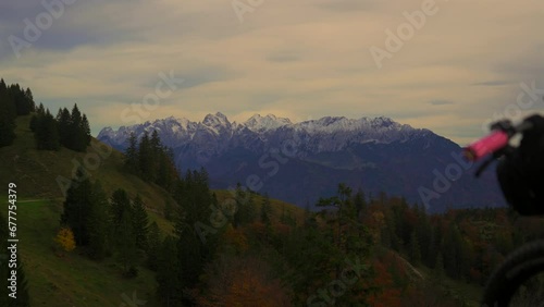 E bike against of snowy Austrian Alps. Mountain bicycle on background cliffs in bavaria mountain range. Rental mountain e bikes. Mountain biking in Oberaudorf mountains. Kleiner und grossen ettenstein photo