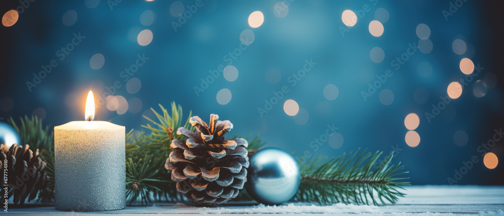 Christmas - Banner Of 1 candle and xmas ornament, Pine-cones And green Spruce Branches minimal blue background and lights in the back, with empty copy space