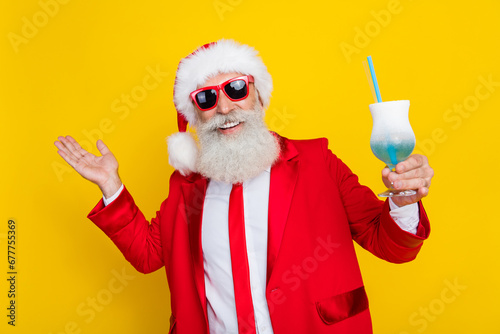 Photo of excited cheerful man hand hold cocktail glass say toast enjoy event isolated on yellow color background photo