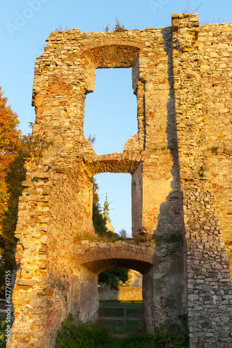 Window openings in old brick wall against blue sky. Ruins of the castle in Bodzentyn. Swietokrzyskie province, Poland.