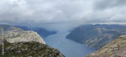 Beautiful landscape of a fjord surrounded by the big mountains under the gloomy cloudy sky