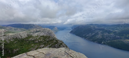 Beautiful landscape of a fjord surrounded by the big mountains under the gloomy cloudy sky