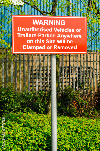 No Parking sign, indicating cars will be clamped and towed away photo