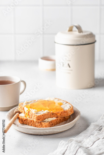 Toasts with butter and honey on light kitchen background. Homemade breakfast sandwich. Healthy vegan food concept
