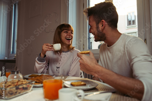 Happy couple making breakfast at home. Concept about lifestyle, healthy food and relationship
