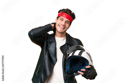 Young caucasian man with a motorcycle helmet over isolated background laughing