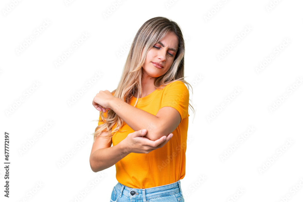 Young Uruguayan woman over isolated background with pain in elbow Young Uruguayan woman over isolated background with pain in elbow