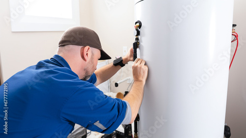 Plumber repairing an hot-water heater. Technician servicing heating boiler. 