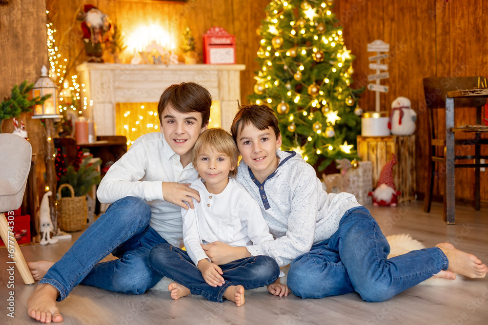 Happy family, children and mom, taking family pictures in a cozy christmas studio Happy family, children and mom, taking family pictures in a cozy christmas studio