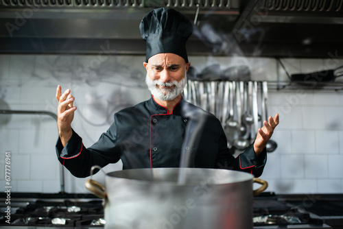 Clumsy chef doing disasters while cooking photo