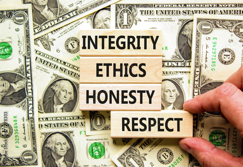 Integrity ethics honesty respect symbol. Concept word Integrity Ethics Honesty Respect on block. Dollar bills. Beautiful background from dollar bills. Business integrity ethics honesty respect concept