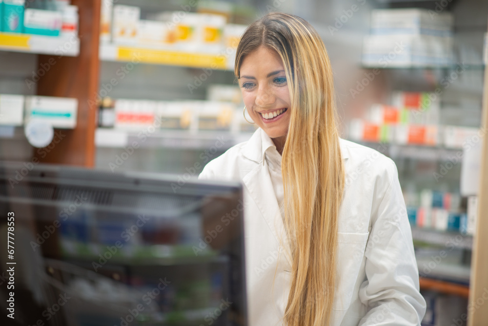 Pharmacist using a desktop computer