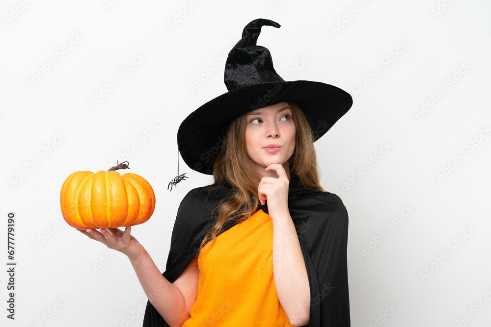 Young pretty woman costume as witch holding a pumpkin isolated on white background having doubts and thinking Young pretty woman costume as witch holding a pumpkin isolated on white background having doubts and thinking