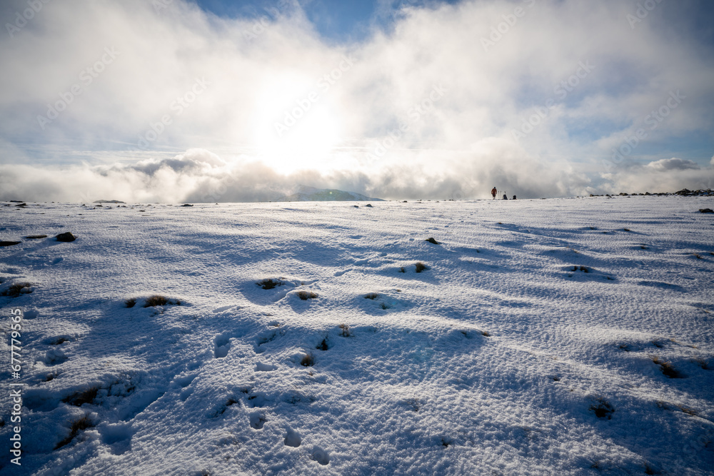 Footprints in the Arctic conditions on top of Great End in the lake district, Cumbria, England.