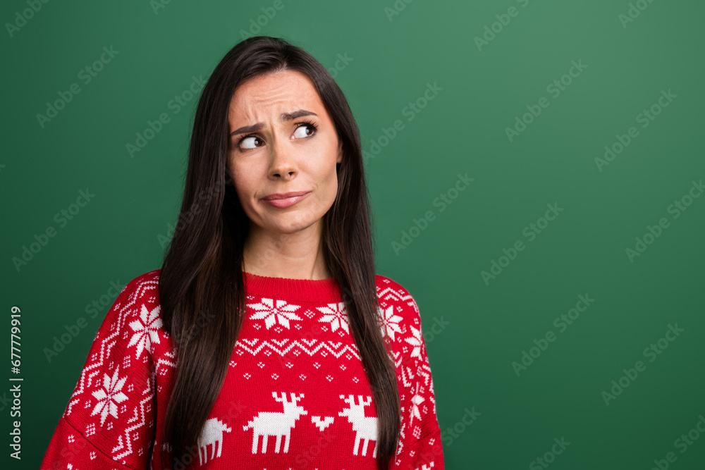 Photo of minded doubtful lady look interested empty space ponder hesitate isolated on green color background Photo of minded doubtful lady look interested empty space ponder hesitate isolated on green color background