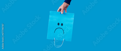 holding an empty sad shopping bag, banner format