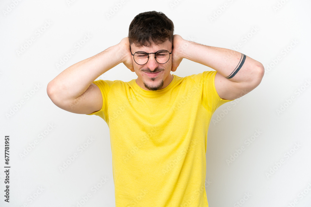 Young caucasian handsome man isolated on white background frustrated and covering ears Young caucasian handsome man isolated on white background frustrated and covering ears