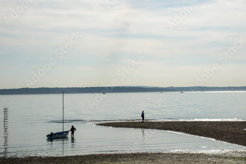 small sailboat in the sea at Lee on Solent Hampshire England with The Isle of Wight in the background