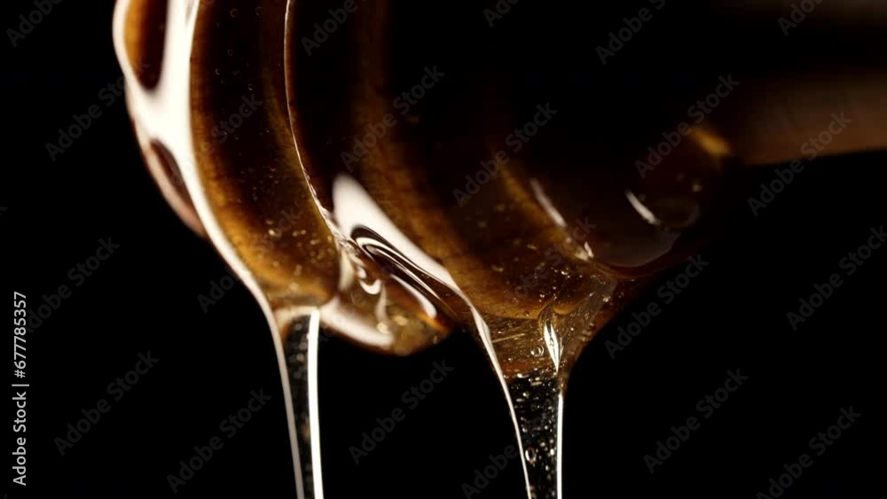 Natural honey dripping, wooden dipper stick, tasty macro details. Sweet essence
