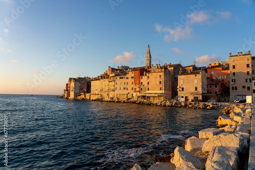 warm sunlight hit the city of Rovinj with the adriatic sea and rocks photo