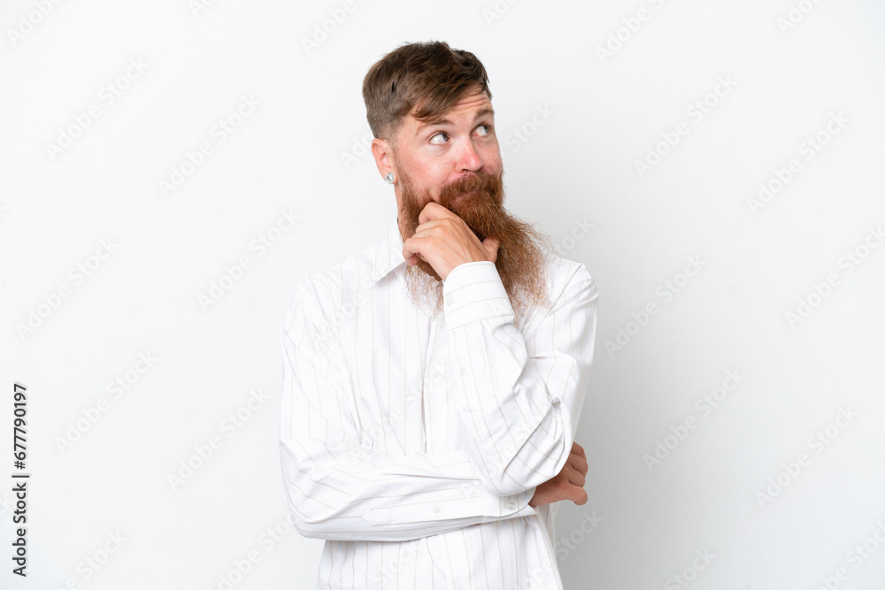 Redhead man with long beard isolated on white background thinking an idea while looking up Redhead man with long beard isolated on white background thinking an idea while looking up