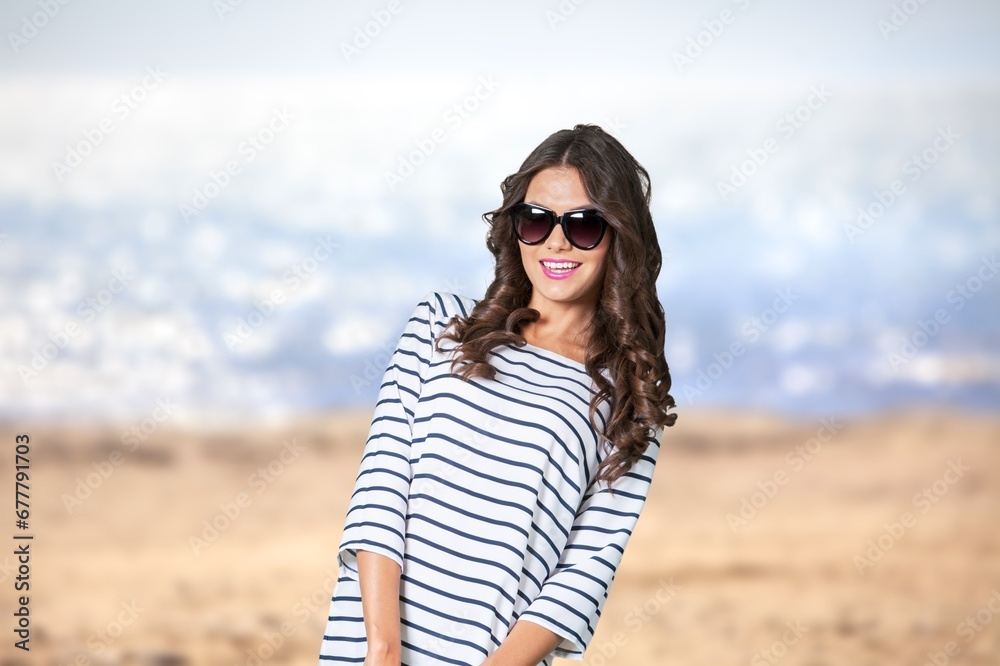 Portrait of smiling young woman at the beach
