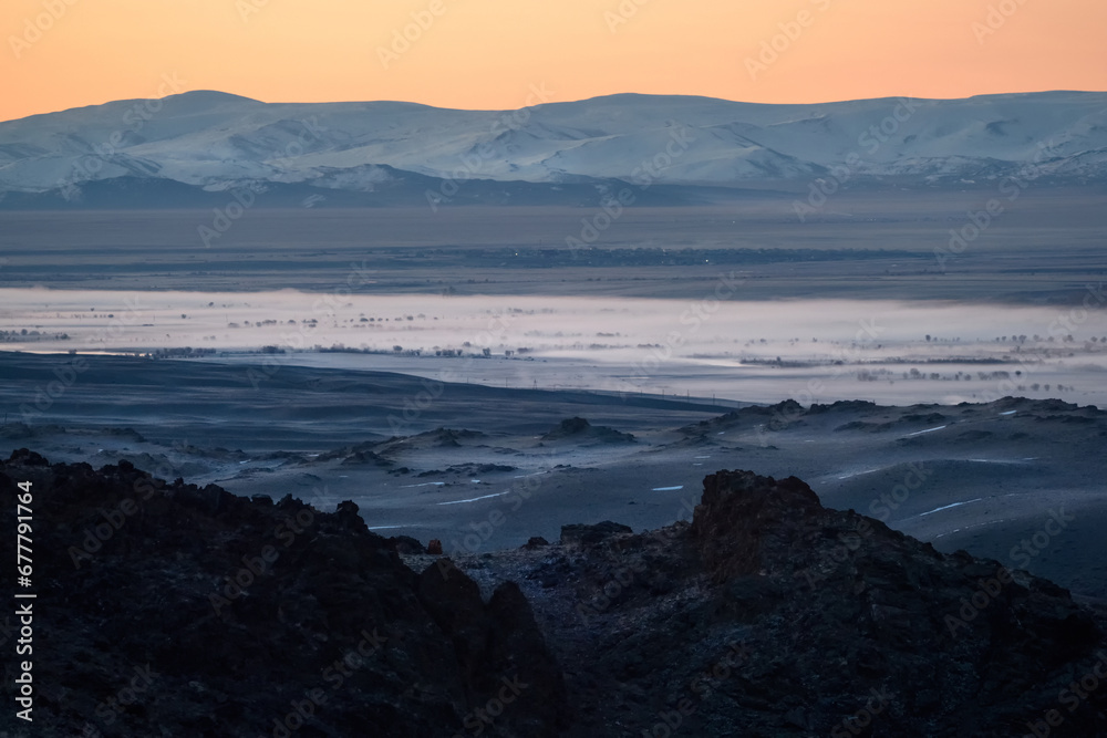 Fototapeta premium Highland river valley with morning fog on a background of snow covered mountains and glaciers with beautiful sunrise. in the steppe near the mountains during the autumn. Altai region.