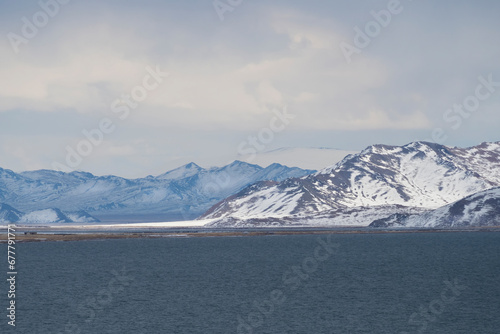 Snow-covered winter pastel colors landscape. View of the blue da