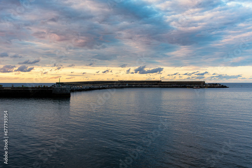 Mutriku breakwater wave plant above a colorful sky at sunset, Mutriku, Gipuzkoa, Basque Country, Spain photo