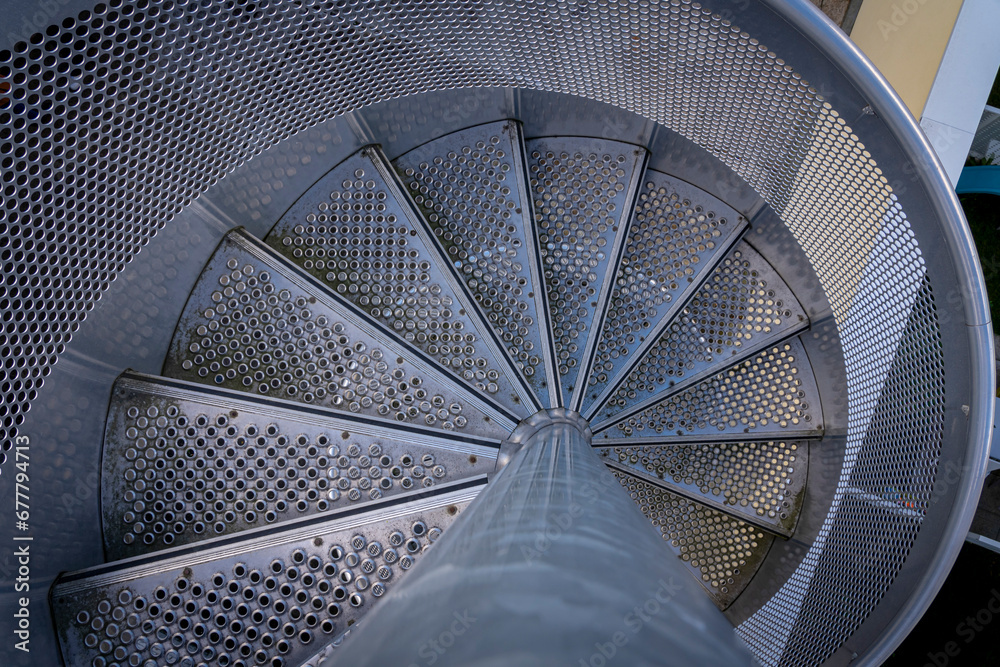 Obraz premium Ivry-Sur-Seine, France - 09 27 2021: View of a circular metal staircase seen from above.