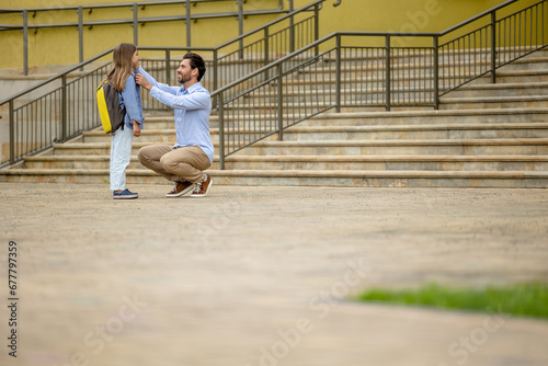 Dark-haired man sending his daughter to school © zinkevych
