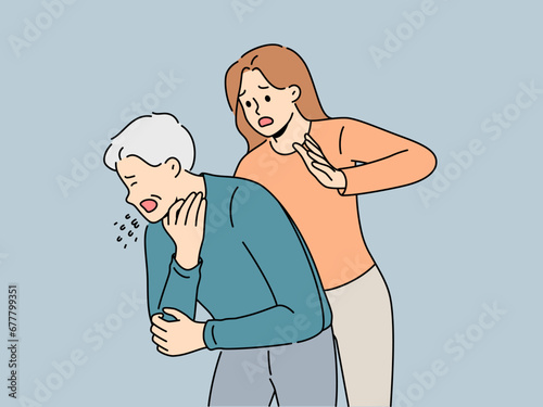 Woman performs heimlich maneuver for choking old man who needs help due to airway obstruction. Sick human choked on food and coughed standing near girl ready to do heimlich maneuver