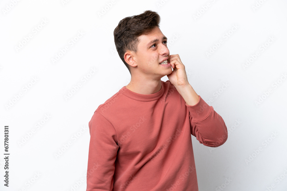 Young handsome Brazilian man isolated on white background is a little bit nervous